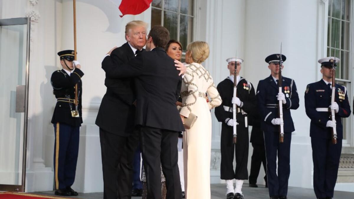 US President Donald Trump and First Lady Melania Trump greet French President Emmanuel Macron and his wife, Brigitte Macron, for a State Dinner at the White House in Washington, DC, April 24, 2018. 
ludovic MARIN / AFP