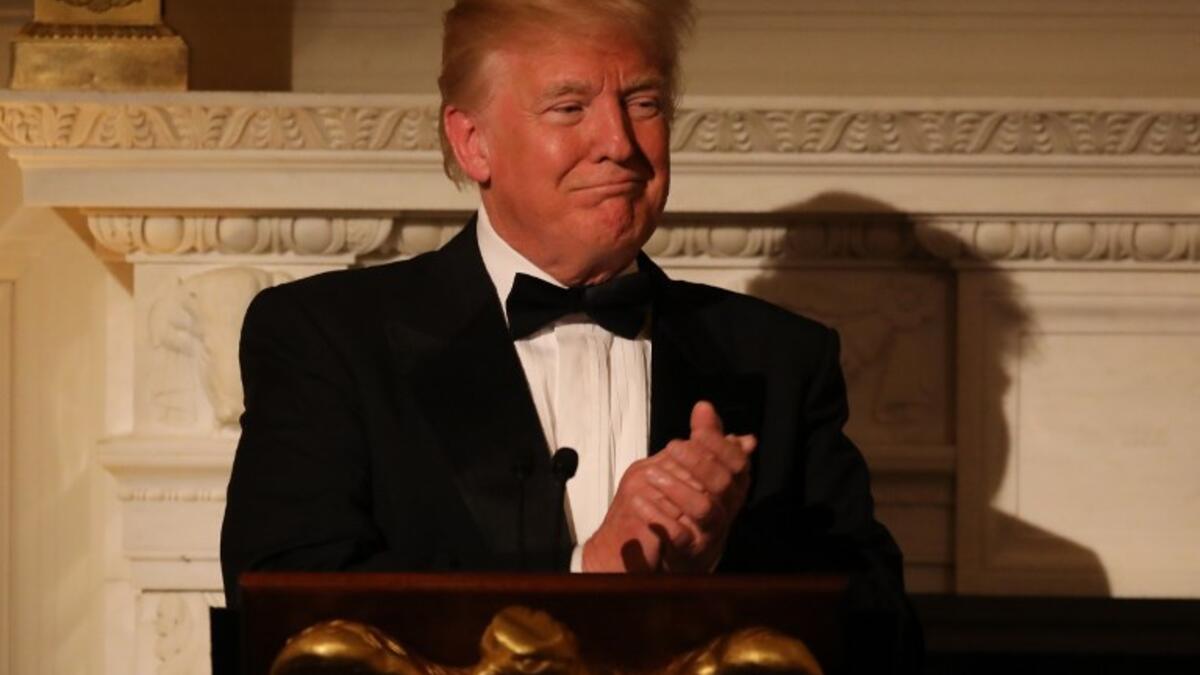 US President Donald Trump applauds during the State Dinner for French President Emmanuel Macron at the White House in Washington, DC, April 24, 2018. 
Ludovic MARIN / AFP