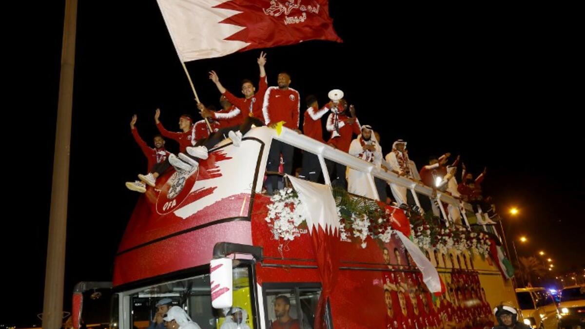 Qatari national football team players and staff celebrate at Doha Corniche in Doha on February 2, 2019, as they come back from the United Arab Emirates with the trophy after winning the 2019 AFC Asian Cup football tournament.
KARIM JAAFAR / AFP