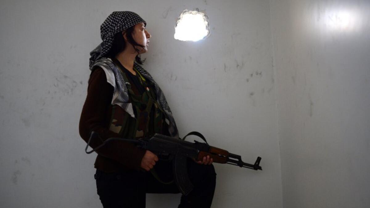 In Aleppo Kurdish soldiers have been a major influence in the fight against both Daesh and the regime. "We’re not just a pretty picture. We are a way of thinking," YPJ Gen. Narin Afrin told FT Magazine. Here a woman watches government forces through the wall in the central city. (AFP/Dimitar Dilkoff)