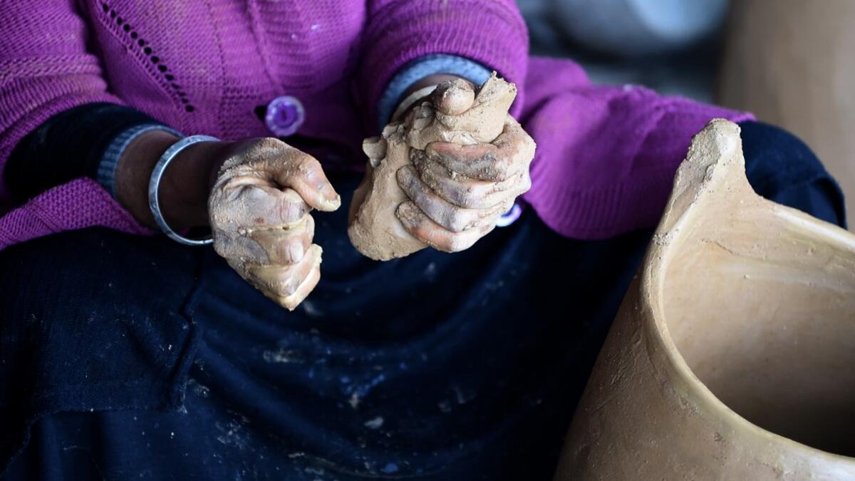 Sabiha Ayari, a Tunisian potter in her fifties, works in the village of Sejnane in the northern Tunisian province of Bizerte, about 120 kilometres (75 miles) west of the capital Tunis.  FETHI BELAID / AFP