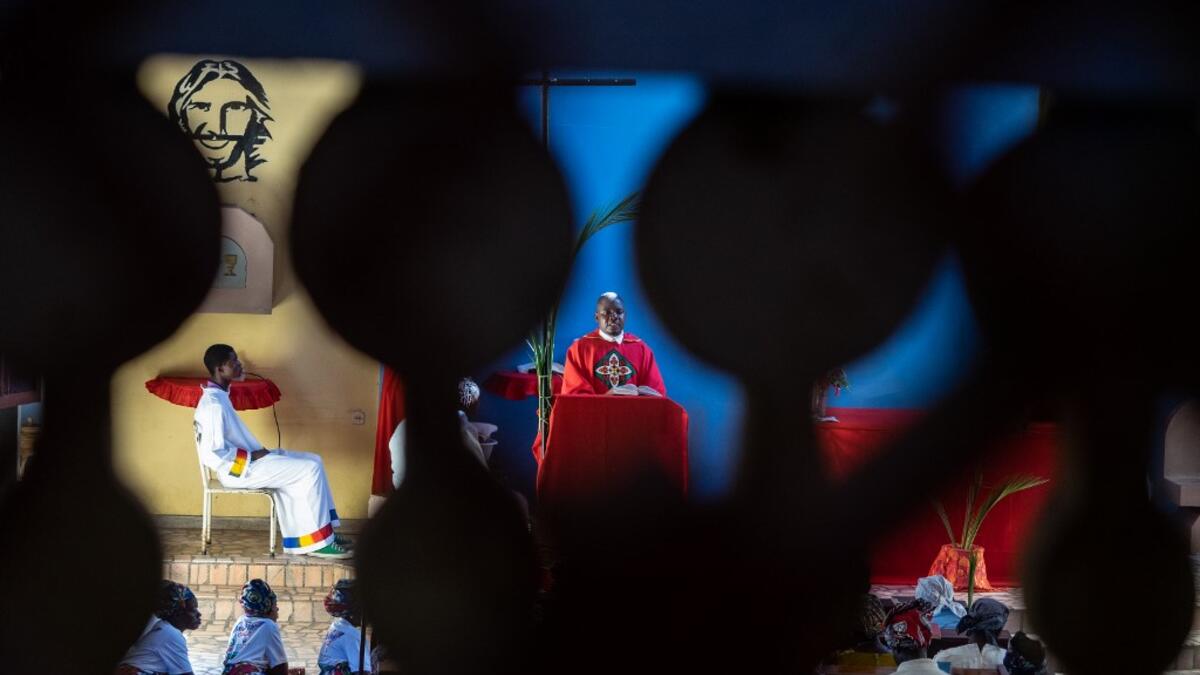 Father Celso Taibo attend a mass during Palm Sunday on April 14, 2019 at Lady of Grace Parish Catholic Church in Barrio Manasse, Buzi District, Sofala Province, Mozambique. Congregants marched the streets of Buzi town skipping rubbles to pass huge fallen trees and buildings with no roofs, windows or doors, one month following the cyclone Idai that killed more than 600 people and displaced 150 000 people in Mozambique.  Zinyange AUNTONY / AFP