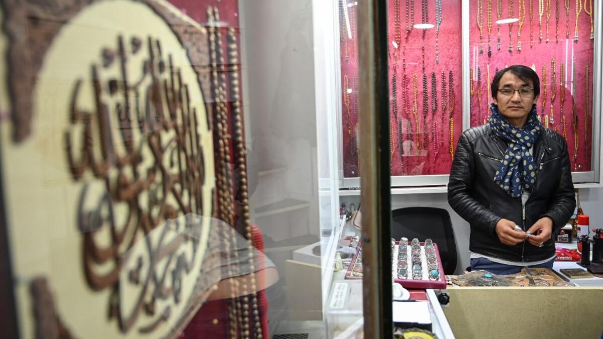 Hadi Ekhlas, engraver, poses for a picture in his workshop at the Grand Bazaar in Istanbul.  OZAN KOSE / AFP