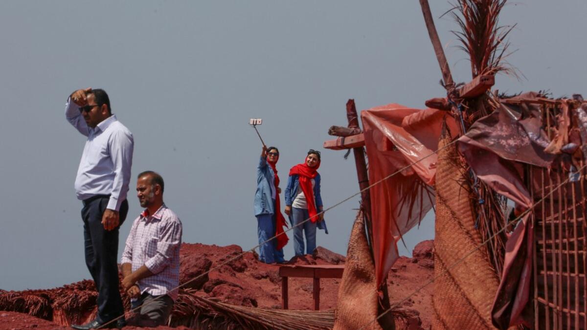 Visitors take a selfie picture on the Hormuz Island in the Gulf Strait of Hormuz, off the Iranian port city of Bandar Abbas, on April 29, 2019.  ATTA KENARE / AFP