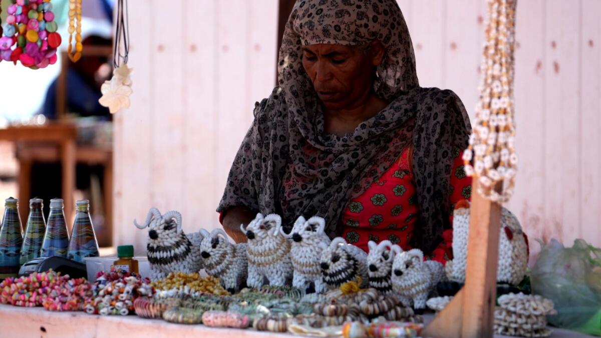 A woman sells souvenirs on the Hormuz Island in the Gulf Strait of Hormuz, off the Iranian port city of Bandar Abbas, on April 29, 2019.  ATTA KENARE / AFP