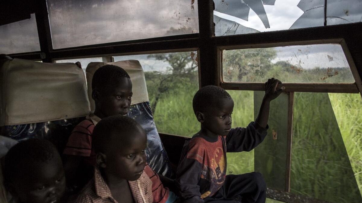 Young South Sudanese refugees are transported from the border of South Sudan and the Democratic Republic of the Congo (DRC) to a refugee settlement site. JOHN WESSELS / AFP