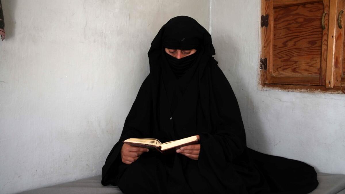 Hasna Dbeis, a 30-year-old former detainee in a Syrian-regime jail, reads a book at her home in the town of Maarat Nasrin in the rebel-held part of the Syrian Idlib province  Aaref WATAD / AFP