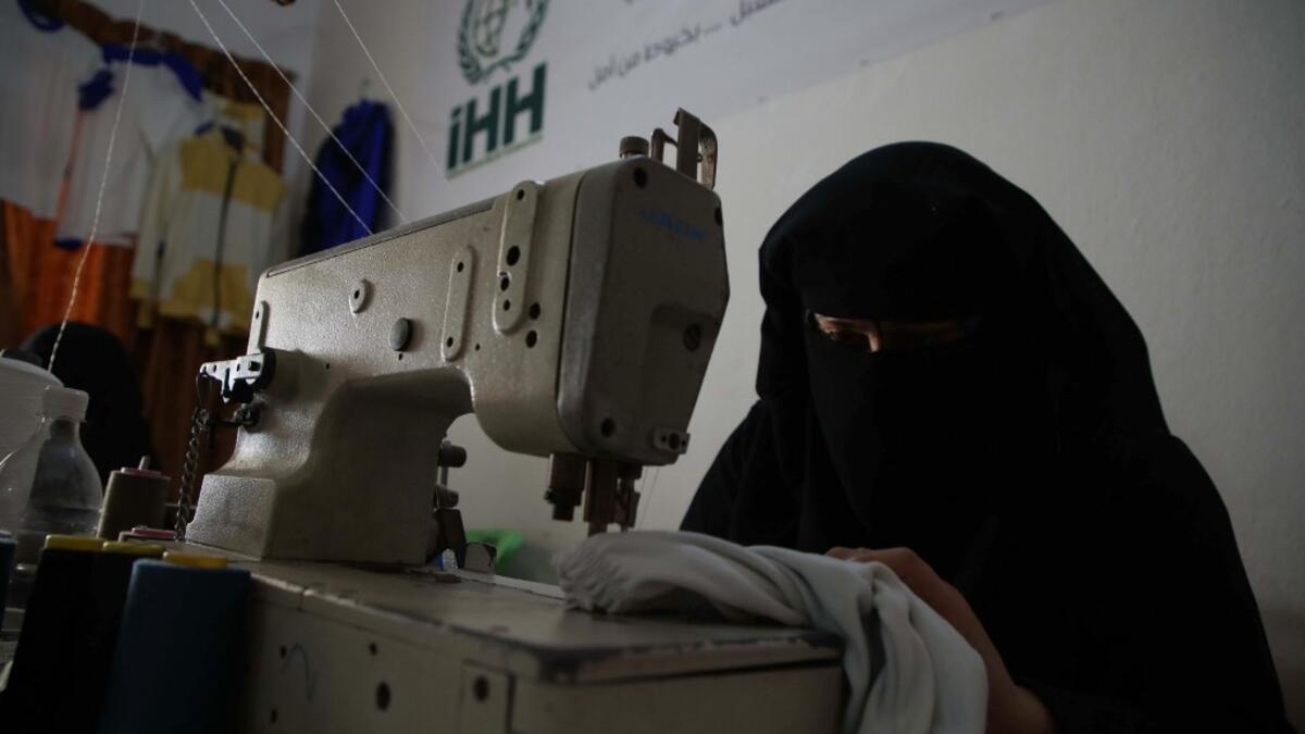 Hasna Dbeis, a 30-year-old former detainee in a Syrian-regime jail, works at a workshop employing former female detainees, in the town of Maarat Nasrin, in the rebel-held part of the Syrian Idlib province  Aaref WATAD / AFP