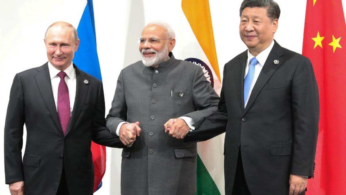 Russian President Vladimir Putin, Indian Prime Minister Narendra Modi and Chinese President Xi Jinping hold a meeting on the sidelines of the G20 summit in Osaka on June 28, 2019.  Mikhail KLIMENTYEV / SPUTNIK / AFP