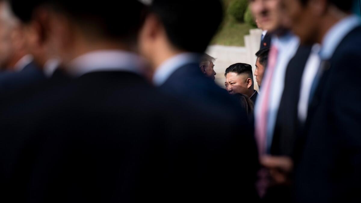 US President Donald Trump and North Korea's leader Kim Jong-un speak near the line of demarcation after meeting in the Demilitarized Zone(DMZ) on June 30, 2019.  Brendan Smialowski / AFP
