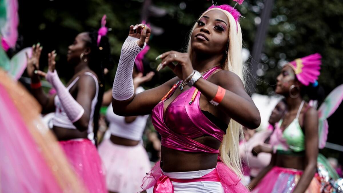 People parade during the Tropical Carnival on July, 7 2019 in Paris.  Kenzo TRIBOUILLARD / AFP