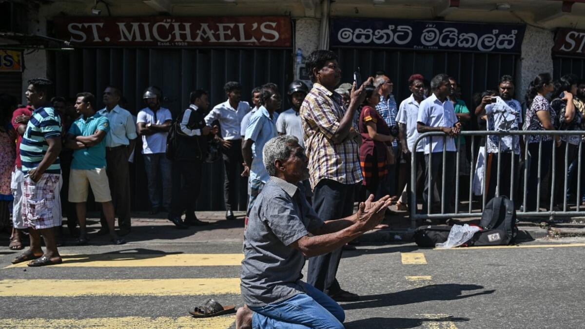 People pray outside the St. Anthony's Shrine in Colombo on April 22, 2019, a day after the building was hit as part of a series of bomb blasts targeting churches and luxury hotels in Sri Lanka. Mohd RASFAN / AFP