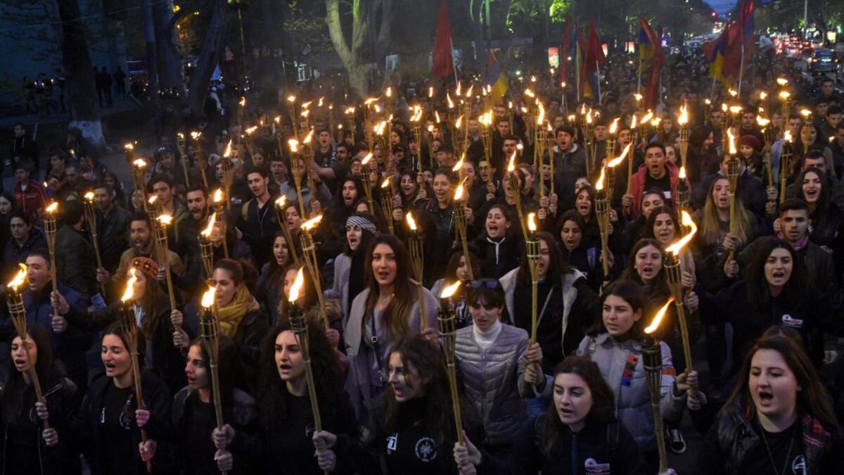 People take part in a torchlight procession as they mark the anniversary of the killing of 1.5 million Armenians by Ottoman forces, Yerevan, April 23, 2019. KAREN MINASYAN / AFP