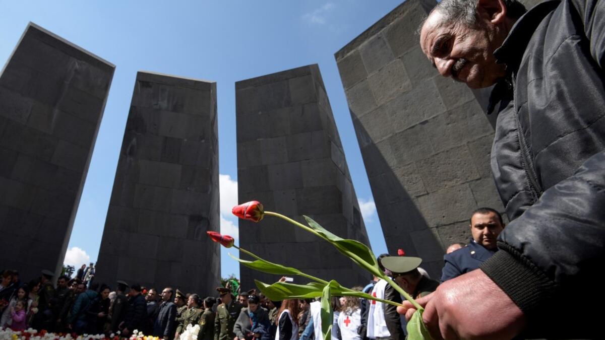 People attend a ceremony commemorating the 104th anniversary of the massacre of 1.5 million of Armenians by Ottoman forces in 1915, at the Tsitsernakaberd memorial in Yerevan on April 24, 2019.  KAREN MINASYAN / AFP