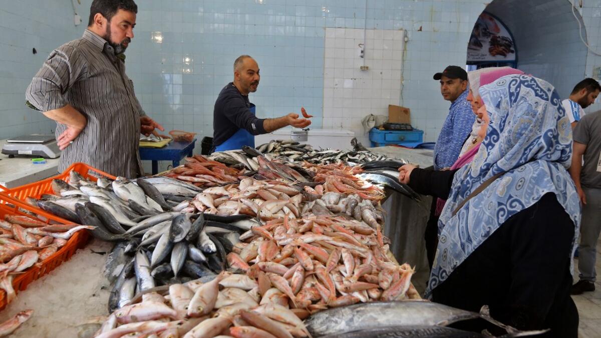 Libyans buy fresh fish at a market as residents of the capital Tripoli get ready for the beginning of the fasting month of Ramadan on May 1, 2019. Mahmud TURKIA / AFP