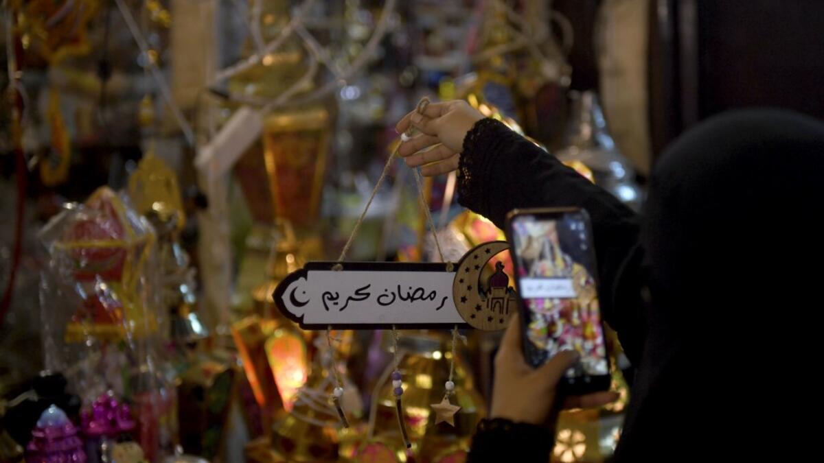 A Saudi woman takes a picture of decorations in the Saudi coastal city of Jeddah on May 3, 2019, ahead of the Muslim holy fasting month of Ramadan.  Amer HILABI / AFP