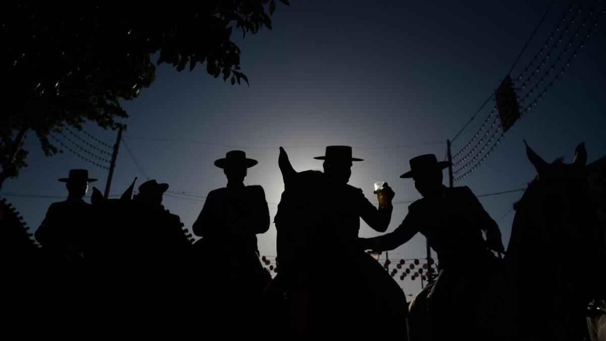 Horsemen drink typical "rebujito" (Sherry with lemon soda) during the "Feria de Abril" (April Fair) festival in Seville on May 6, 2019. CRISTINA QUICLER / AFP