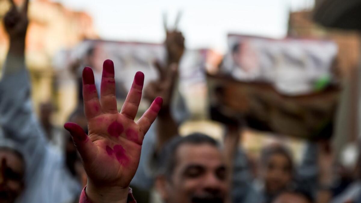 Egyptian people show their inked hands after voting at a polling station during the third day of a referendum on constitutional amendments, at a school in shamma village in the northern Nile delta province of Menoufia, on April 22, 2019.  Mohamed el-Shahed / AFP