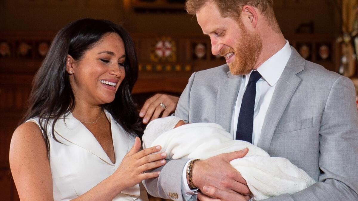 Britain's Prince Harry, Duke of Sussex (R), and his wife Meghan, Duchess of Sussex, pose for a photo with their newborn baby son, Archie Harrison Mountbatten-Windsor, in St George's Hall at Windsor Castle in Windsor, west of London on May 8, 2019.  Dominic Lipinski / POOL / AFP
