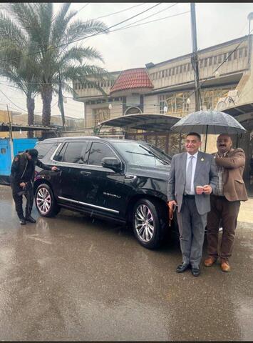 نائب عراقي يستمتع بالمطر وسط معاناة مرافقيه