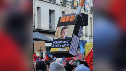 Macron photo printed on cigarette pack warning label