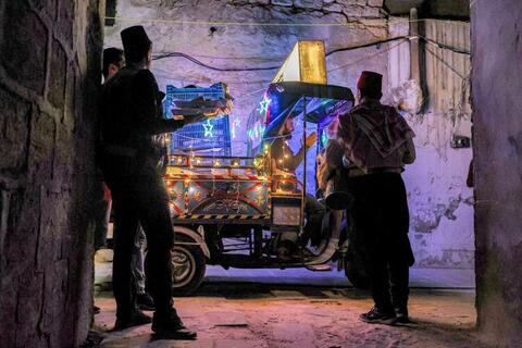 In Pictures: Volunteers and a 'Musaharati' Deliver Pre-Dawn Meals in Syria